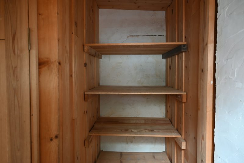 トイレ用洗面台の横にある大きな収納棚。そのままでも、カーテンなどで目隠しをしても